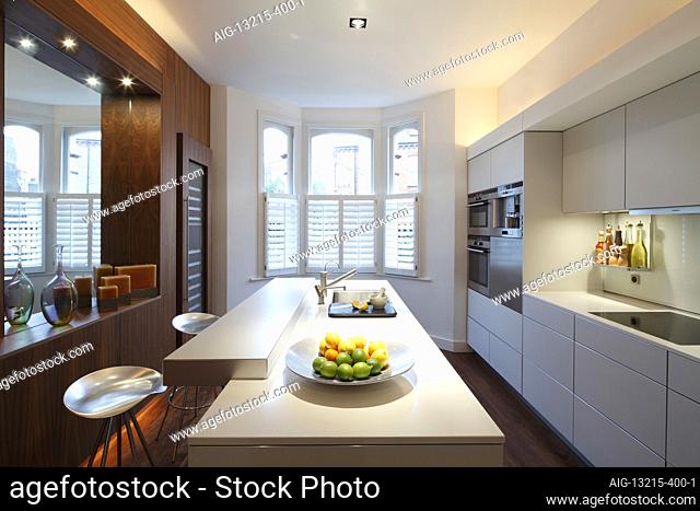 Modern kitchen looking towards bay window (lights on) | Architect: MAP Projects |