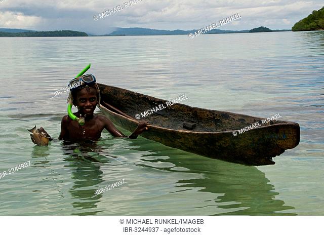 Boy fishing with his canoe and harpoon