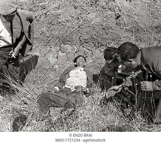 Man killed by Salvatore Giuliano. Some men looking at the body of one of the victim of Italian bandit Salvatore Giuliano. Italy, 1940s