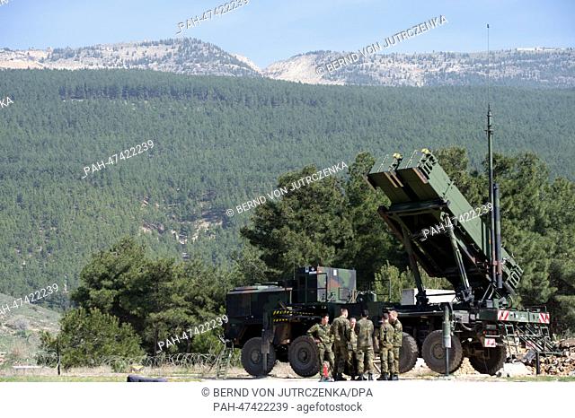 German soldiers are lined up before a .'Patriot' surface-to-air missile of the German Bundeswehr in Kahramanmaras, Turkey, Germany, 25 March 2014