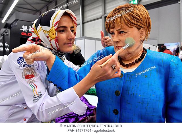 The pastry chef Tuba Geckil from Turkey works on a likeness of German chancellor Angela Merkel during a competition at the international cooking olympia in...