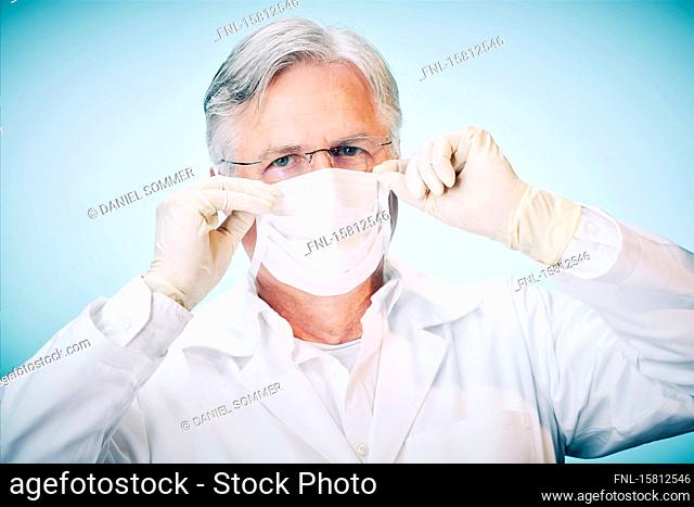 Grey-haired man pulls up mouthguard