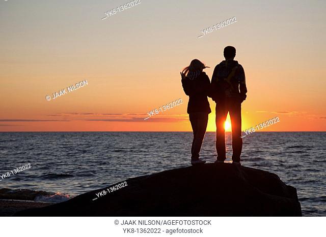 Couple Silhouettes at Sunset on Beach