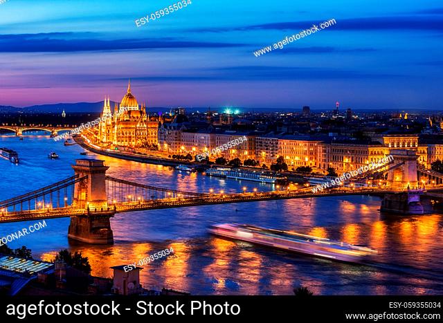 Budapest city at blue hour twilight with illuminated Chain Bridge and Hungarian Parliament on Danube River, tranquil evening cityscape