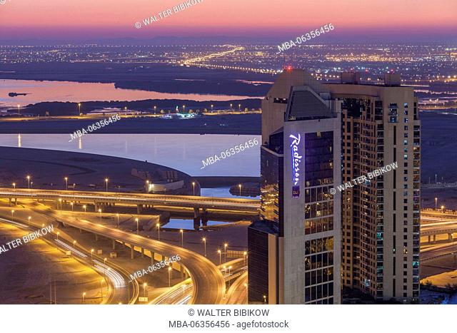 UAE, Dubai, Downtown Dubai, elevated desert and highway view towards Ras Al Khor with Radisson Hotel, dusk