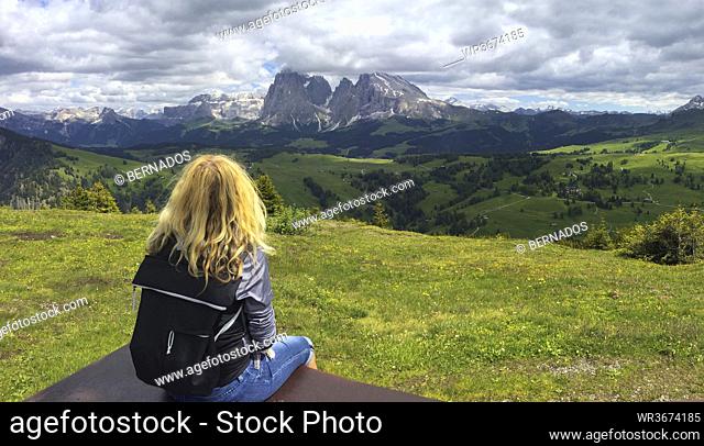Italy, South Tyrol, Seis am Schlern, Blonde woman admiring scenic landscape of Seiser Alm