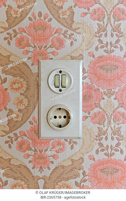 Old socket and light switch, wallpaper from the sixties, Stuttgart, Baden-Wuerttemberg, Germany, Europe