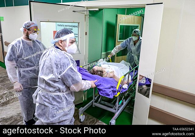 RUSSIA, ST PETERSBURG - DECEMBER 11, 2023: Medical workers move a COVID-19 ward patient on a gurney at St George City Hospital
