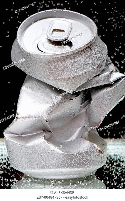 Crumpled beverage can with bubbles