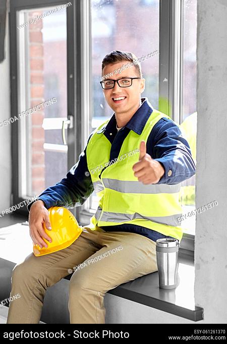 happy builder with tumbler showing thumbs up