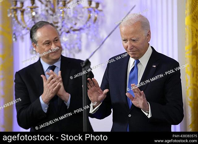 United States President Joe Biden arrives with second gentleman Doug Emhoff to speak a Hanukkah reception in the East Room of the White House in Washington
