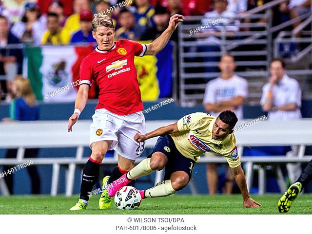 Manchester United's Bastian Schweinsteiger competes for the ball against Club America's Osvaldo Martinez (R) during the soccer friendly match between Manchester...