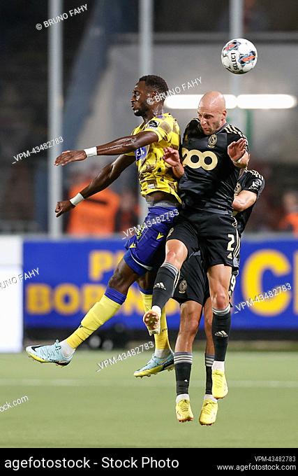 STVV's Mory Konate and Standard's Gilles Dewaele fight for the ball during a soccer match between Sint-Truidense VV and Standard de Liege