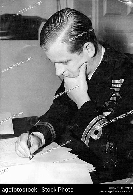 Lietenant H.R.H. The Duke of Edinburgh looks thoughtful as he works out a problem in the staff college study at the Royal Naval college, Greenwhich