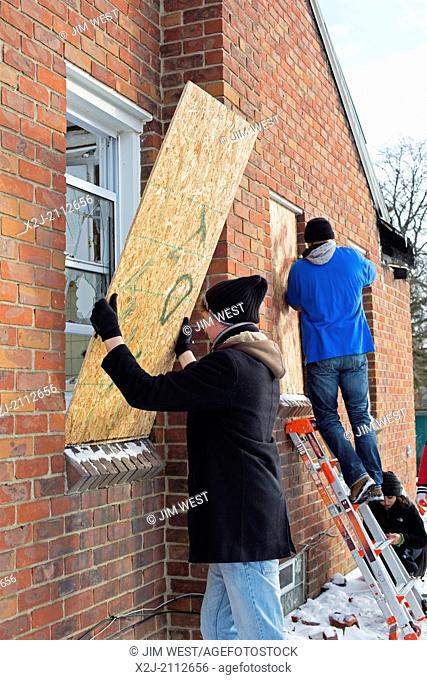 Detroit, Michigan - Volunteers from Wayne State University clear debris and board up vacant houses near Cody High School on the Martin Luther King Jr