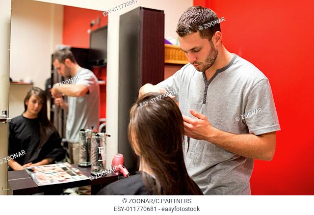 Male hairdresser cutting hair