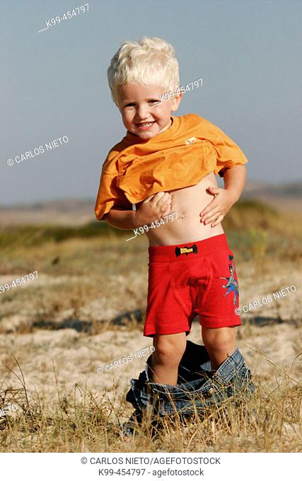 3 year old blond boy playing