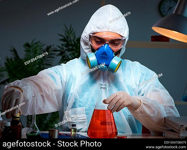 The young make scientist working with dangerous hazardous substances
