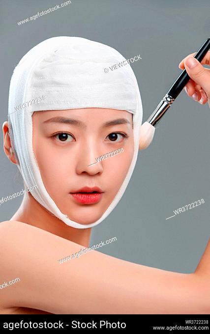 The pretty woman wearing a bandage makeup