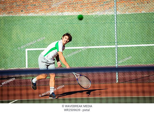 Man playing tennis in the court