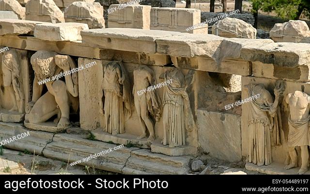 close up shot of carved reliefs at the theatre of dionysus in athens, greece