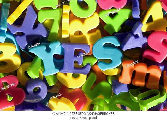 YES spelled out with toy letters, plastic alphabet