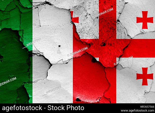 flags of Italy and Georgia painted on cracked wall