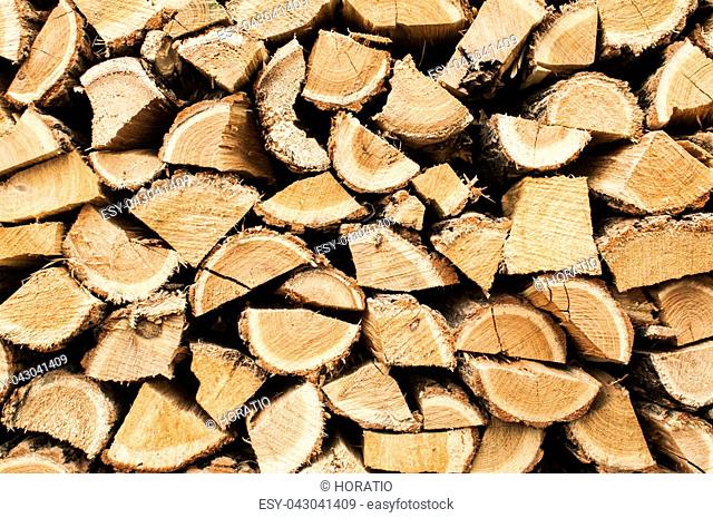 Stacked cut oak firewood closeup as background