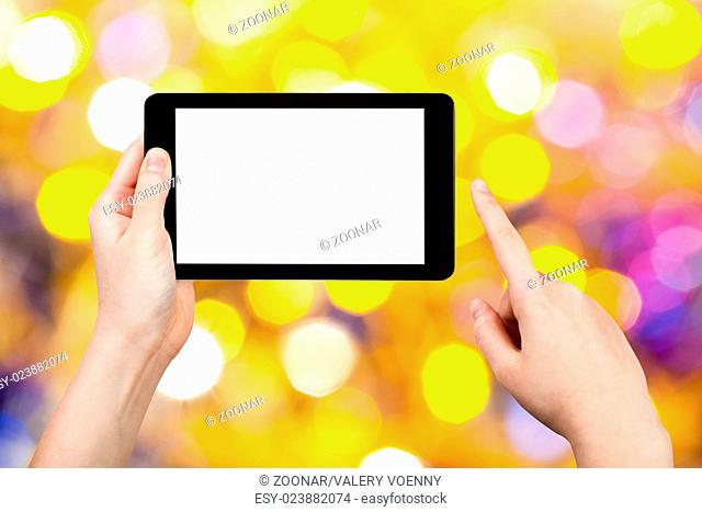 hand with tablet pc on yellow and blue background
