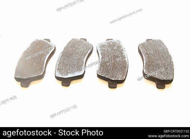 Two pairs of old brake pads disk isolated white background, São Paulo, Brazil
