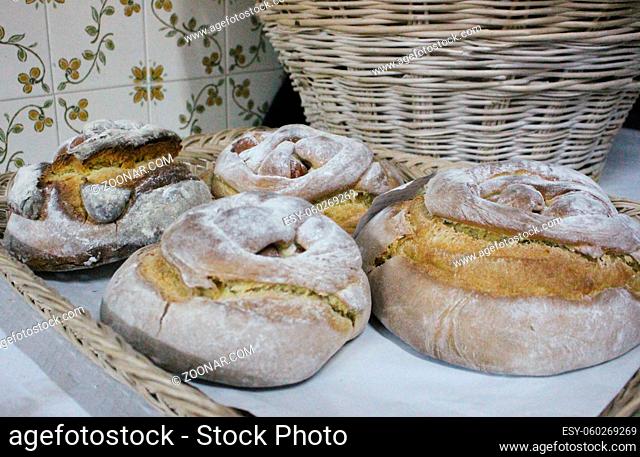 Horizontal photo of typical Portuguese Easter cakes, also called Folar or folares, with traditional portuguese tiles in background