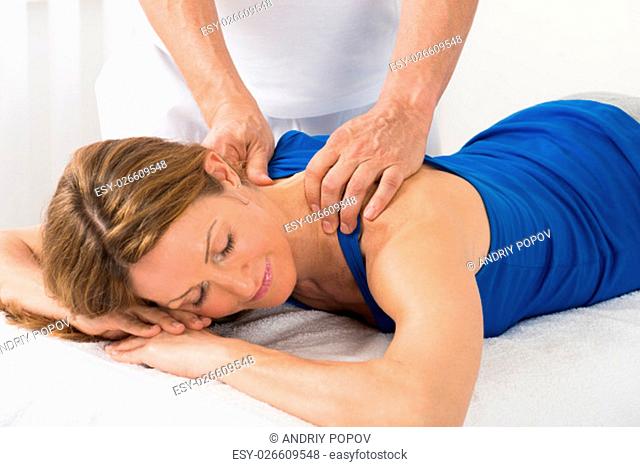 Close-up Of Person Giving Massage To Mature Woman