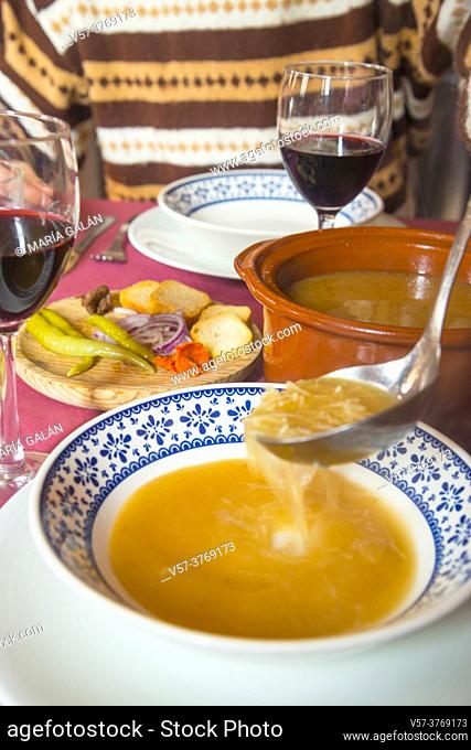 Serving cocido soup. Madrid, Spain