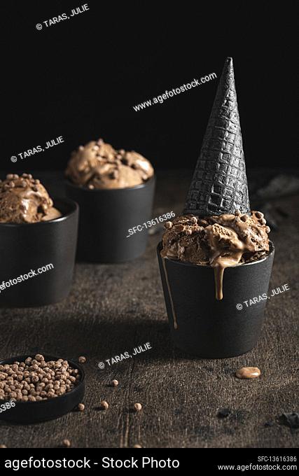 Chocolate ice cream with black waffle cone