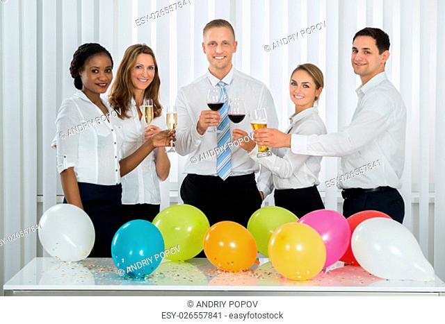 Team Of Happy Businesspeople Having Champagne In Office