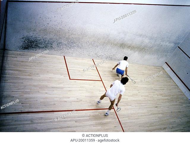 Two men playing racquetball