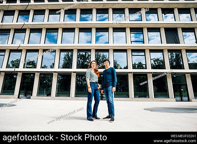 Couple standing together on footpath
