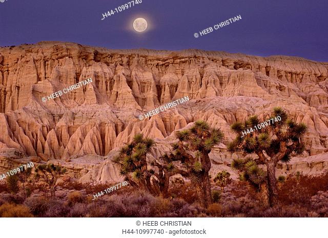 Full moon setting over Badlands at Red Rock Canyon State Park, Dawn, California, United States of America