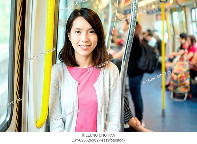 Asian woman inside train compartment