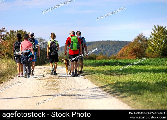 03 October 2023, Baden-Württemberg, Hayingen: Hikers are out in the sunshine in the Swabian Alb. Photo: Thomas Warnack/dpa