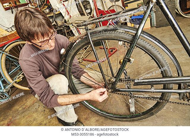 A technician restoring a vintage bicycle
