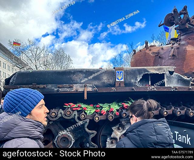 GERMANY, BERLIN - FEBRUARY 26, 2023: Citizens keep bringing flowers to a wrecked Russian tank put on display outside the Russian Embassy in order to commemorate...