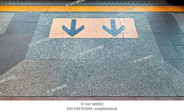 Yellow arrow direction points to exit of door sky train