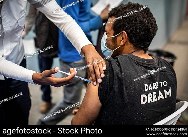 08 March 2021, Israel, Meitar: A Palestinian cross-border worker receives his dose of the COVID-19 vaccine at a vaccination centre opened at the checkpoint of...