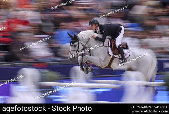 10 April 2022, Saxony, Leipzig: Jack Whitaker of Great Britain rides Equine America Valmy de la Lande in the final of the Longines Fei Jumping World Cup at the...