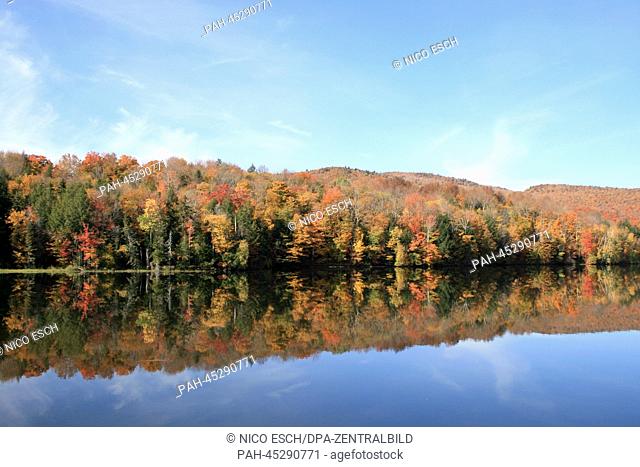 Autumnally coloured trees mirror in the water of a lake near Killington, Vermont, USA, 03 October 2013. Photo: Nico Esch - NO WIRE SERVICE |