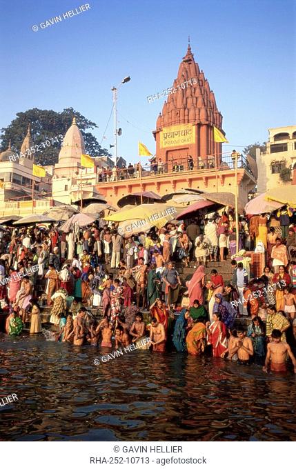 Hindus bathing in the early morning in the holy river Ganges Ganga along Dasaswamedh Ghat, Varanasi Benares, Uttar Pradesh state, India, Asia