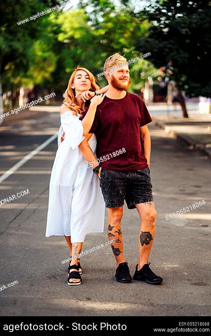 beautiful couple posing outdoors at the camera