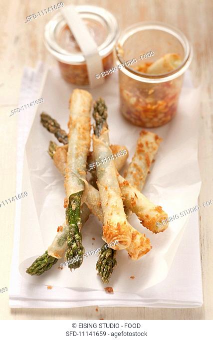 Green asparagus in spring roll pastry with a chilli, cucumber and peanut dip