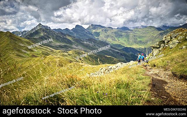 Mother with two children hiking in alpine scenery, Passeier Valley, South Tyrol, Italy